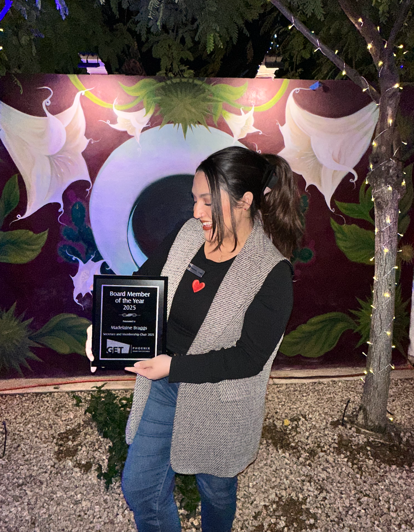 Madelaine Braggs holding her 2025 GET Phoenix Board Member of the Year award